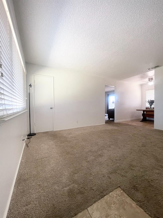 interior space featuring a textured ceiling and visible vents