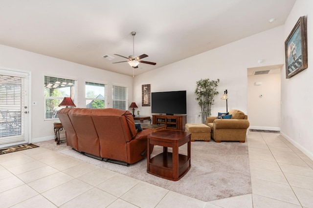 living area featuring light tile patterned floors, ceiling fan, visible vents, and baseboards
