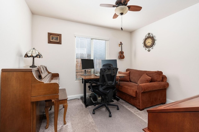 office space with carpet flooring, baseboards, and ceiling fan