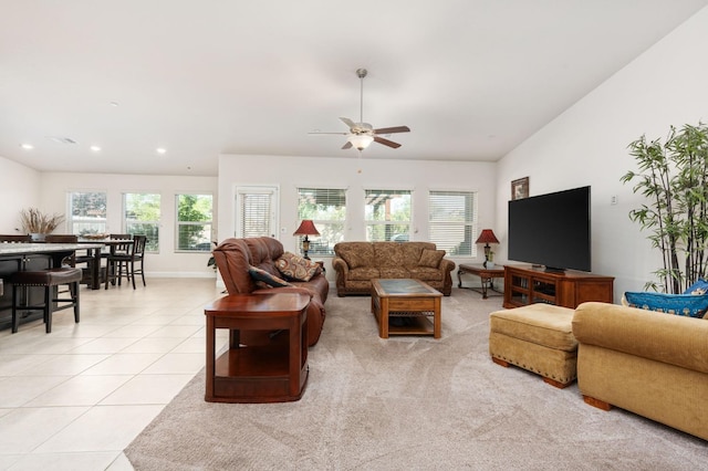 living area with light tile patterned floors, ceiling fan, plenty of natural light, and visible vents