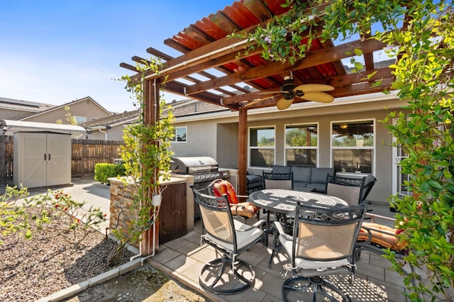 view of patio / terrace with a pergola, outdoor dining area, an outbuilding, fence, and a storage unit