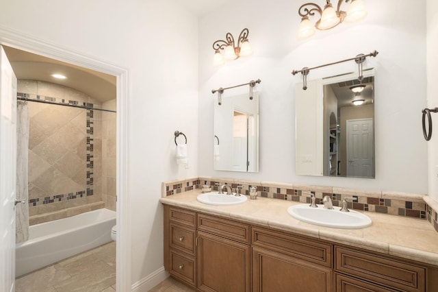 bathroom featuring double vanity, toilet, visible vents, and a sink