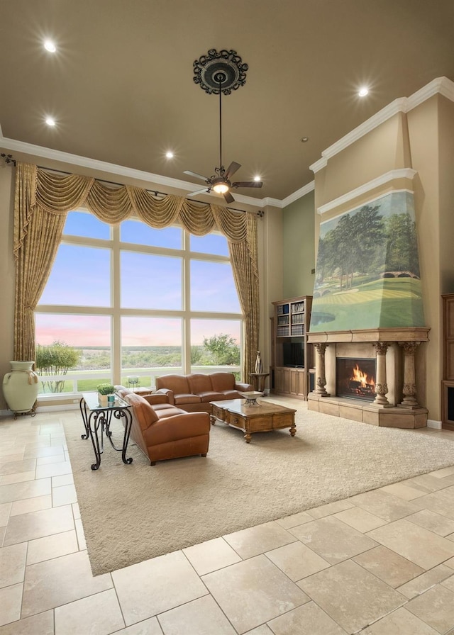 5136 W Bluff Ave, Fresno, CA 93722 - living room with a warm lit fireplace, crown molding, a ceiling fan, recessed lighting, and a towering ceiling
