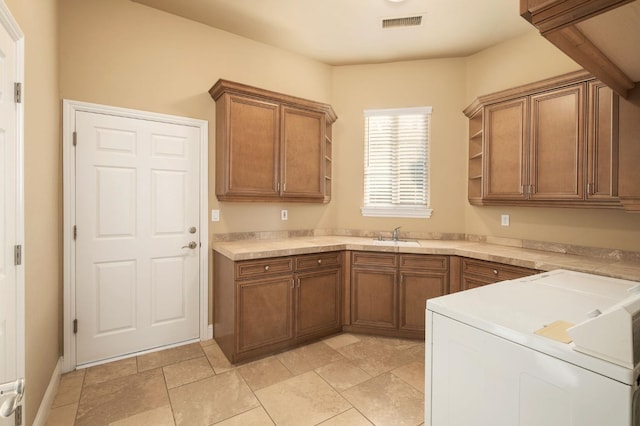laundry area with cabinet space, independent washer and dryer, visible vents, and a sink