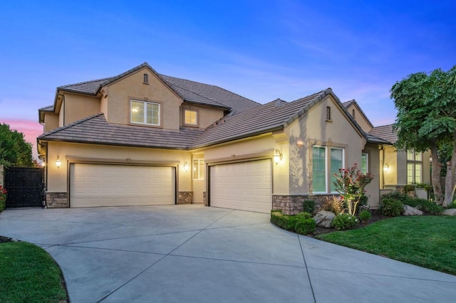 view of front of property with a lawn, driveway, stone siding, and stucco siding