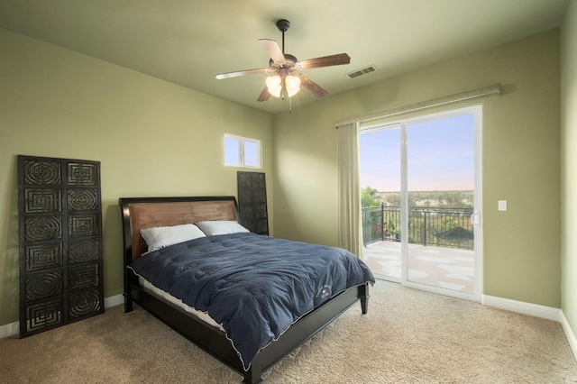 bedroom featuring carpet floors, access to outside, baseboards, and visible vents