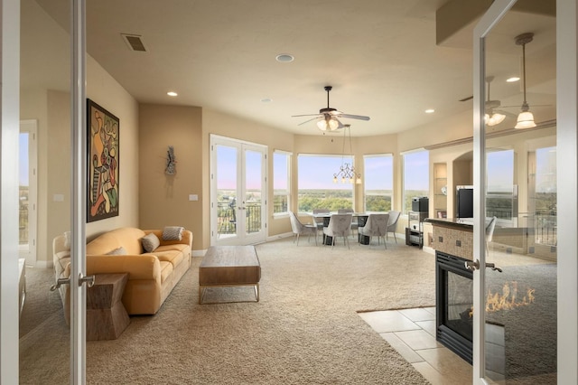 living room featuring ceiling fan, visible vents, baseboards, light carpet, and recessed lighting