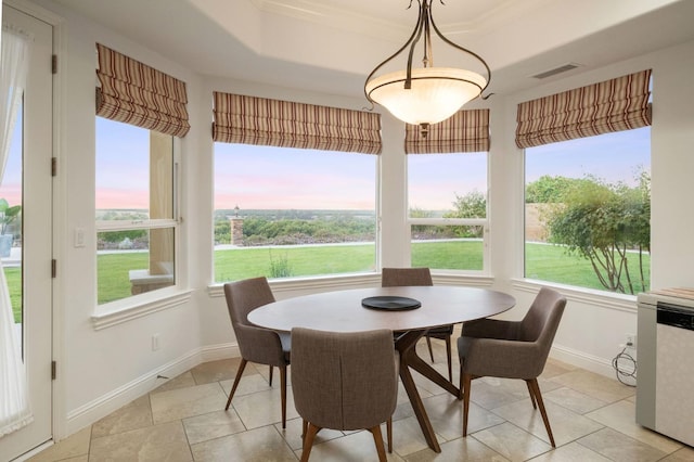 dining area with visible vents, crown molding, light tile patterned floors, baseboards, and a tray ceiling