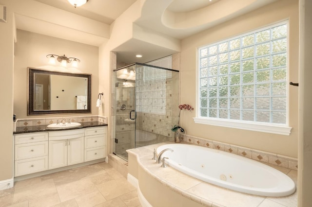 bathroom featuring vanity, a whirlpool tub, a shower stall, and visible vents