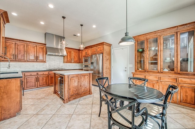 8389 N Paula Ave, Fresno, CA 93720 - kitchen featuring brown cabinetry, tasteful backsplash, wall chimney range hood, appliances with stainless steel finishes, and a sink