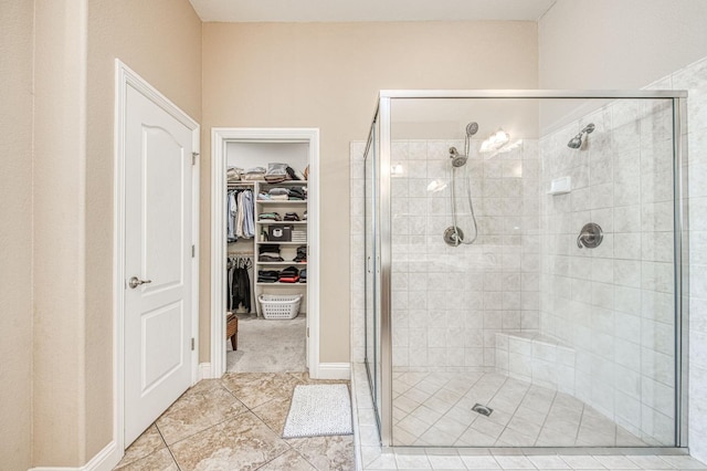 8389 N Paula Ave, Fresno, CA 93720 - bathroom with a shower stall, a walk in closet, and tile patterned floors