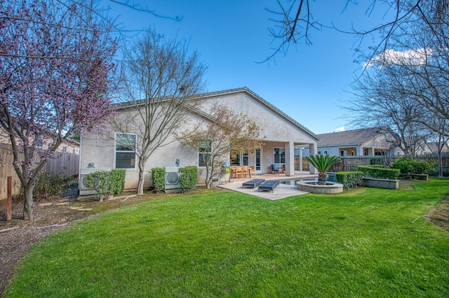 8389 N Paula Ave, Fresno, CA 93720 - back of property with a patio, stucco siding, fence, and a lawn