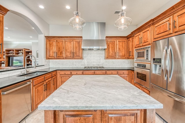 8389 N Paula Ave, Fresno, CA 93720 - kitchen with brown cabinets, wall chimney exhaust hood, a sink, and appliances with stainless steel finishes