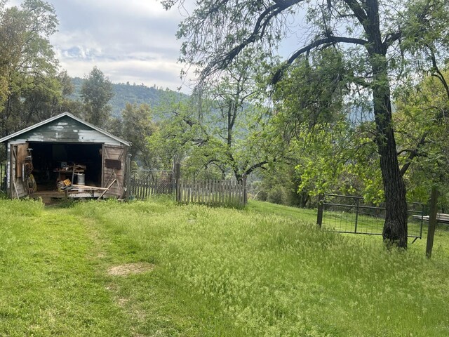 50364 Rd 426, Oakhurst, CA 93644 - view of yard with an outdoor structure, fence, and a storage unit