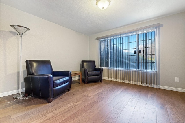 sitting room featuring wood finished floors and baseboards