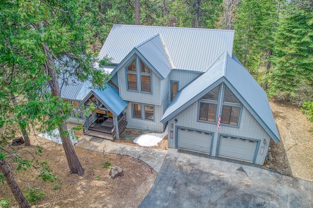 41811 Gray Rock Rd, Shaver Lake, CA 93664 - rustic home with an attached garage, metal roof, driveway, and covered porch