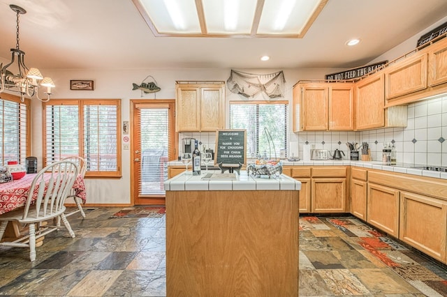 41811 Gray Rock Rd, Shaver Lake, CA 93664 - kitchen with a wealth of natural light, an inviting chandelier, and decorative backsplash