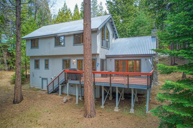 41811 Gray Rock Rd, Shaver Lake, CA 93664 - rear view of house with a chimney, a wooden deck, metal roof, and stairs