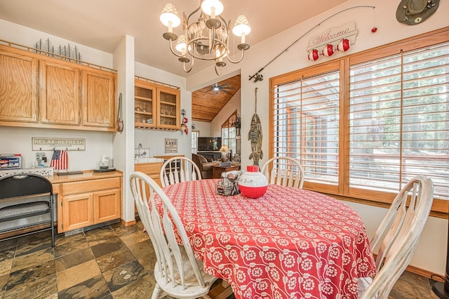 41811 Gray Rock Rd, Shaver Lake, CA 93664 - dining area featuring stone finish floor, ceiling fan with notable chandelier, and vaulted ceiling