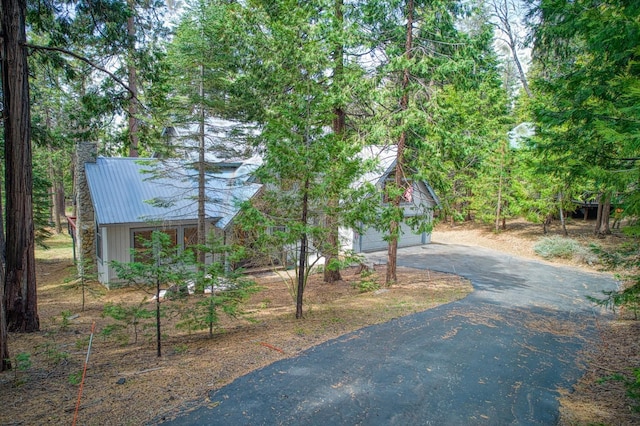 41811 Gray Rock Rd, Shaver Lake, CA 93664 - view of front of house featuring metal roof, driveway, and a chimney