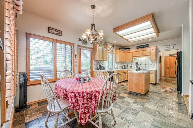 41811 Gray Rock Rd, Shaver Lake, CA 93664 - dining room featuring recessed lighting, stone finish floor, a notable chandelier, and baseboards