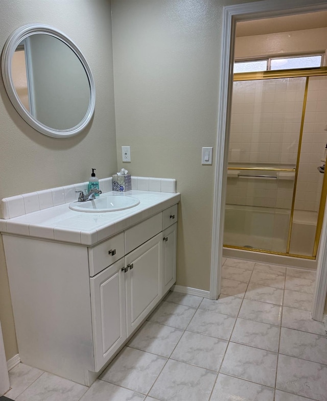 full bathroom with baseboards, a shower stall, marble finish floor, and vanity