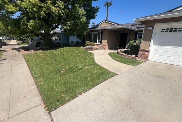1450 W Chennault Ave, Fresno, CA 93711 - ranch-style home with stucco siding, a front lawn, brick siding, and concrete driveway