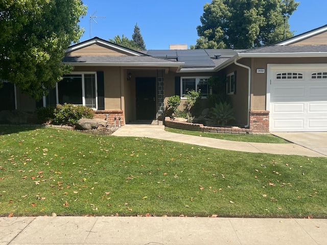 1450 W Chennault Ave, Fresno, CA 93711 - single story home with solar panels, brick siding, an attached garage, a front yard, and stucco siding