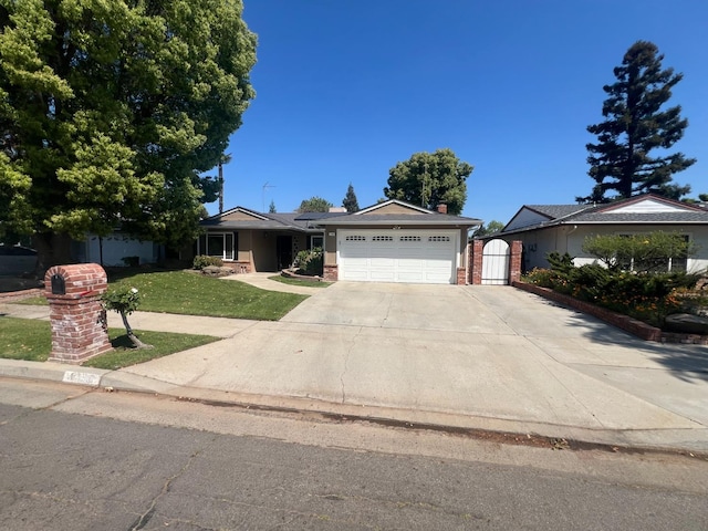 1450 W Chennault Ave, Fresno, CA 93711 - single story home featuring a gate, a front lawn, concrete driveway, brick siding, and a garage