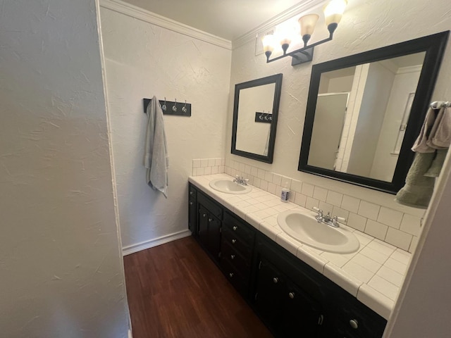 1450 W Chennault Ave, Fresno, CA 93711 - bathroom with decorative backsplash, wood finished floors, a sink, and double vanity