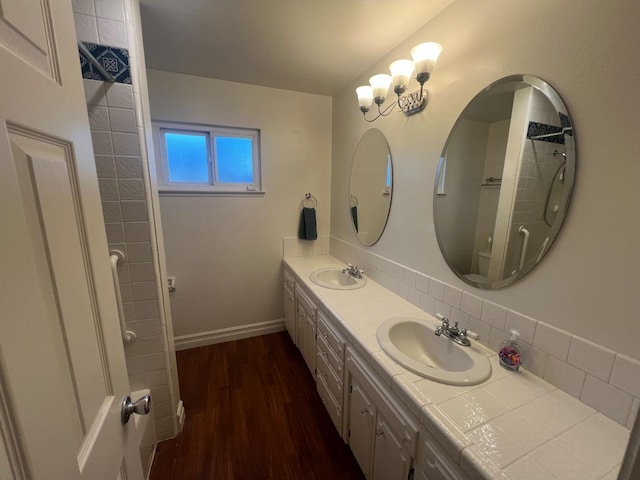 1450 W Chennault Ave, Fresno, CA 93711 - bathroom featuring backsplash, double vanity, wood finished floors, and a sink