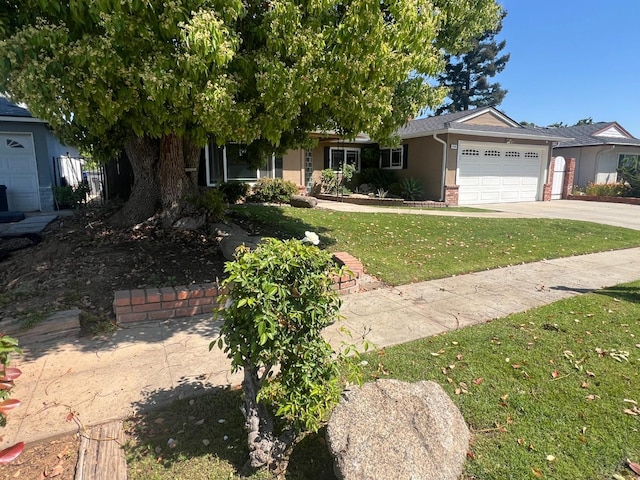 1450 W Chennault Ave, Fresno, CA 93711 - view of front of house with a front lawn, an attached garage, stucco siding, concrete driveway, and brick siding