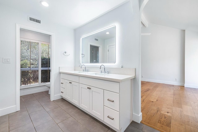 bathroom with recessed lighting, vanity, toilet, visible vents, and baseboards