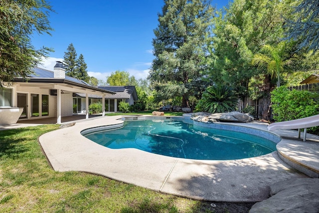 view of swimming pool with a water slide, fence, a fenced in pool, and a patio area