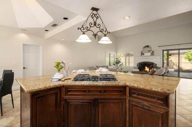 10001 N Pheasant Run Dr, Fresno, CA 93730 - kitchen with gas stovetop, vaulted ceiling, open floor plan, light tile patterned flooring, and healthy amount of natural light