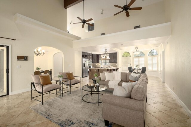 10001 N Pheasant Run Dr, Fresno, CA 93730 - living area featuring a chandelier, ceiling fan, arched walkways, baseboards, and a high ceiling