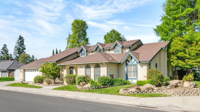 10001 N Pheasant Run Dr, Fresno, CA 93730 - view of front of house with stucco siding, driveway, and a garage