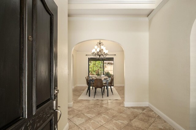 10001 N Pheasant Run Dr, Fresno, CA 93730 - foyer entrance featuring arched walkways, a chandelier, ornamental molding, light tile patterned floors, and baseboards