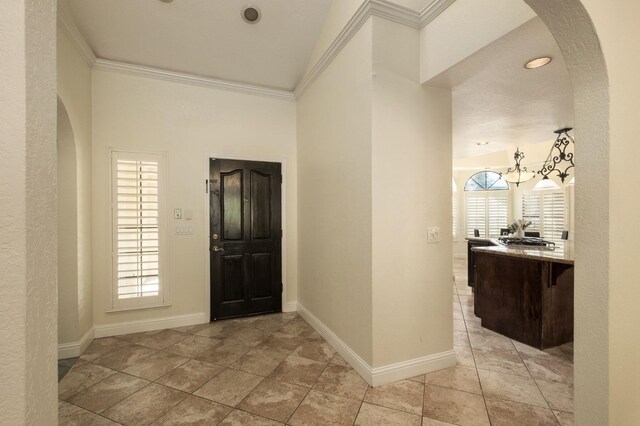 10001 N Pheasant Run Dr, Fresno, CA 93730 - entrance foyer featuring arched walkways, baseboards, crown molding, and high vaulted ceiling
