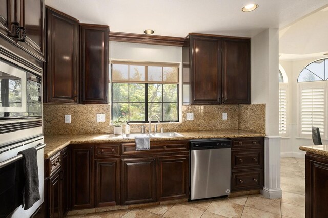 10001 N Pheasant Run Dr, Fresno, CA 93730 - kitchen featuring stainless steel appliances, plenty of natural light, backsplash, dark brown cabinets, and recessed lighting