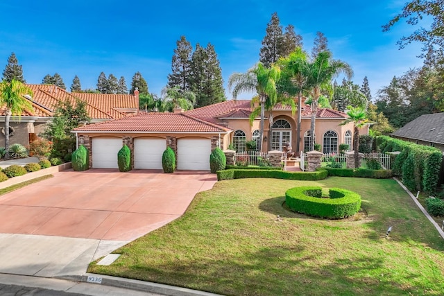 9336 N St Martin Dr, Fresno, CA 93720 - mediterranean / spanish-style house with a tiled roof, a front lawn, stucco siding, an attached garage, and driveway