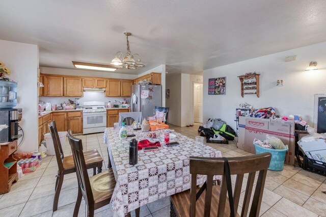dining room featuring an inviting chandelier and light tile patterned flooring