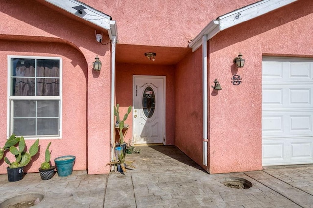 property entrance with stucco siding