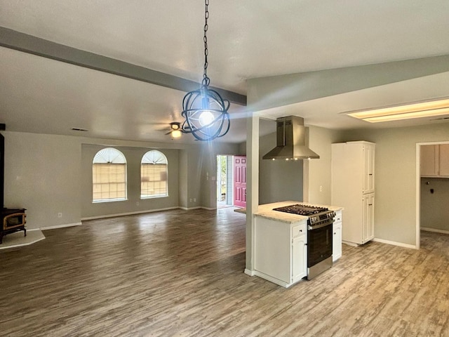 28813 Limestone Cir, Coarsegold, CA 93614 - kitchen with wall chimney range hood, stainless steel gas stove, light countertops, wood finished floors, and white cabinets