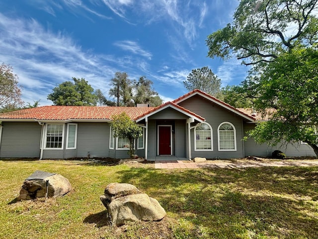 28813 Limestone Cir, Coarsegold, CA 93614 - ranch-style house with a tile roof and a front lawn