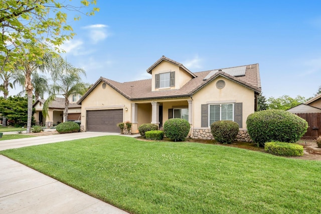 view of front of property with a tiled roof, driveway, a garage, a front yard, and stucco siding