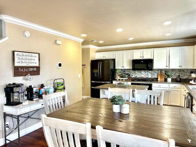 5148 W Pine Ave, Fresno, CA 93722 - dining area featuring recessed lighting, dark wood-type flooring, and crown molding