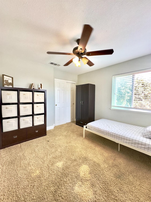 5148 W Pine Ave, Fresno, CA 93722 - bedroom featuring a textured ceiling, ceiling fan, carpet, baseboards, and visible vents