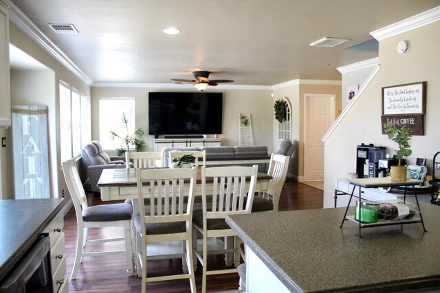 5148 W Pine Ave, Fresno, CA 93722 - dining space with crown molding, a ceiling fan, visible vents, and dark wood finished floors