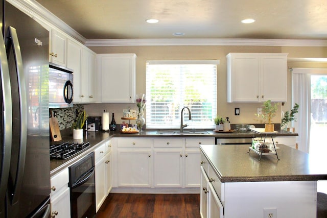 5148 W Pine Ave, Fresno, CA 93722 - kitchen featuring oven, dark countertops, a sink, freestanding refrigerator, and gas stovetop
